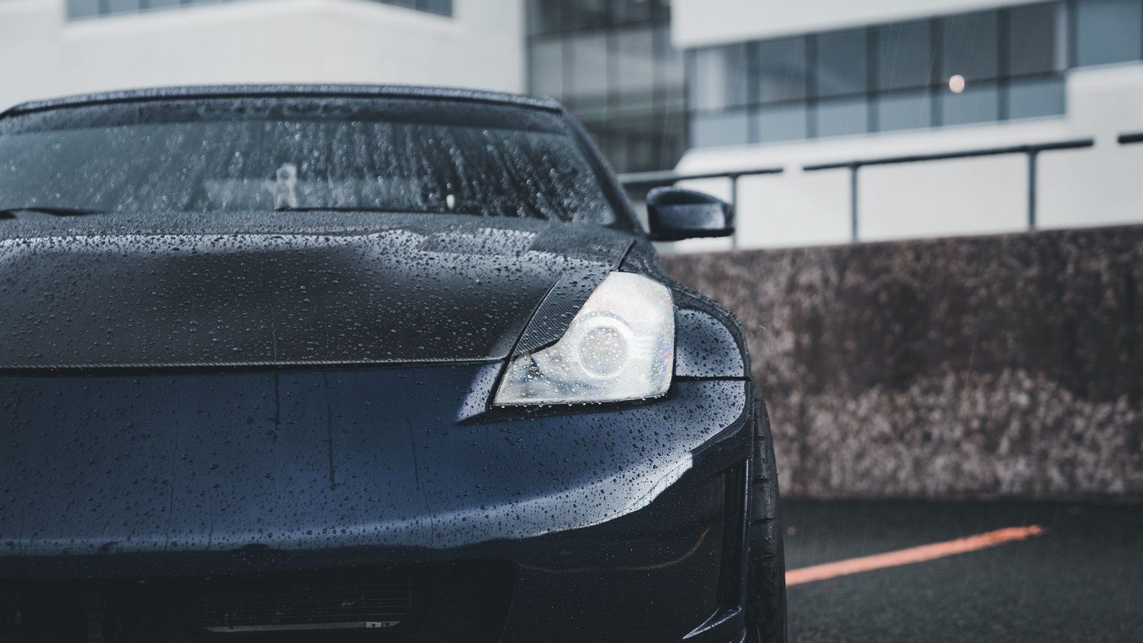 Stock photo of a generic sports car headlight in the rain, illustrative only, not the actual Ferrari Luce