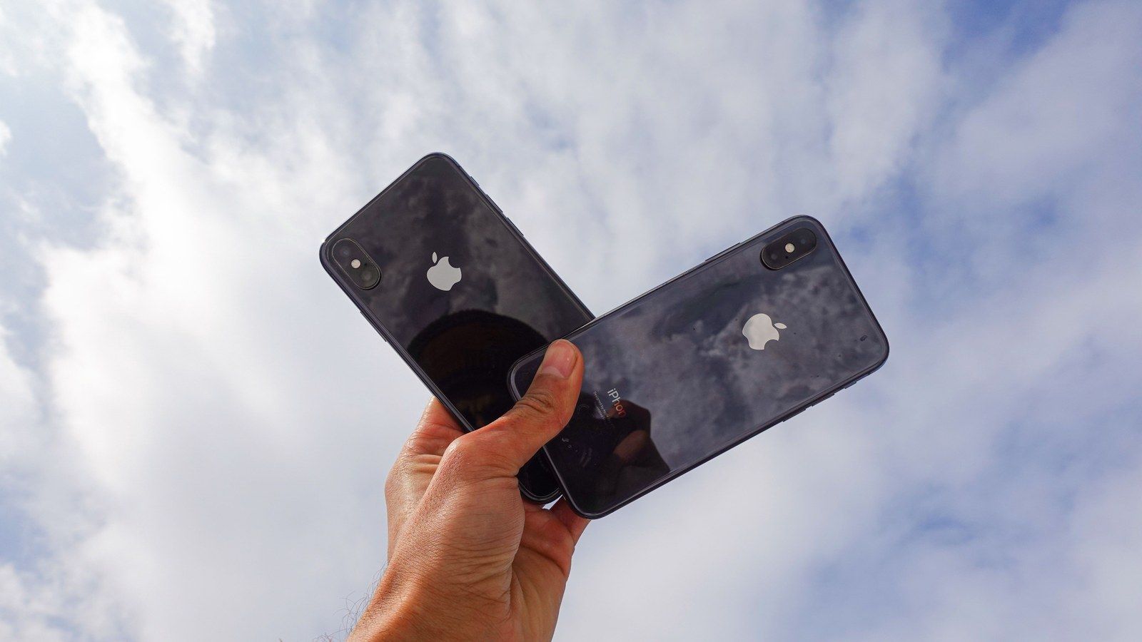 Stock photo of a person holding a smartphone, illustrative only, not an actual Apple product or the AI model discussed