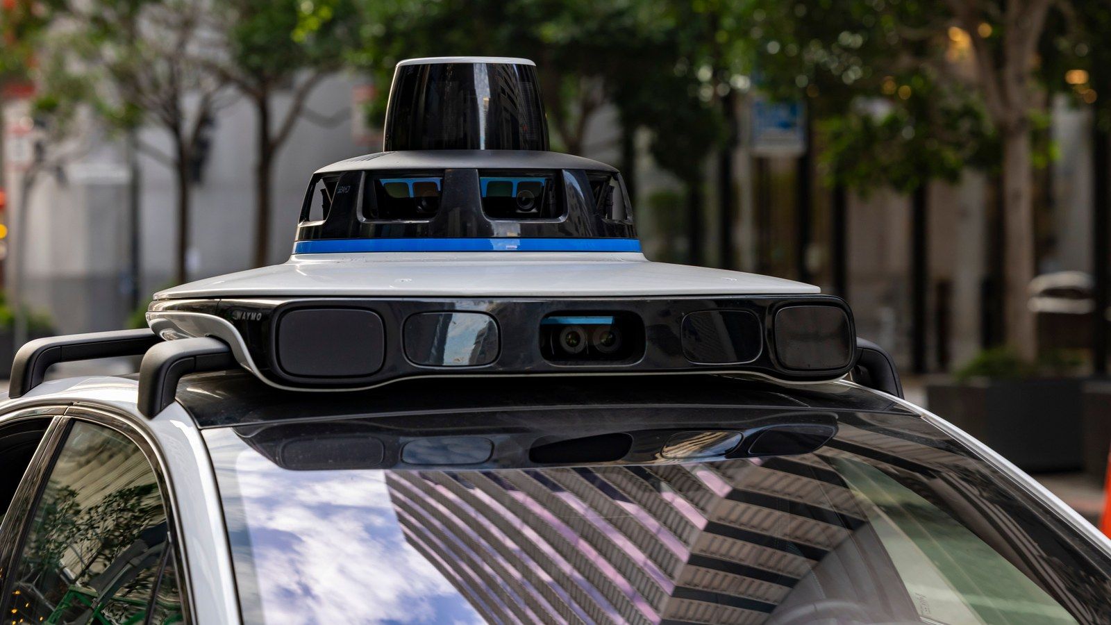 Close-up of a real Waymo autonomous vehicle's rooftop sensor array, not photographed at Allegiant Stadium