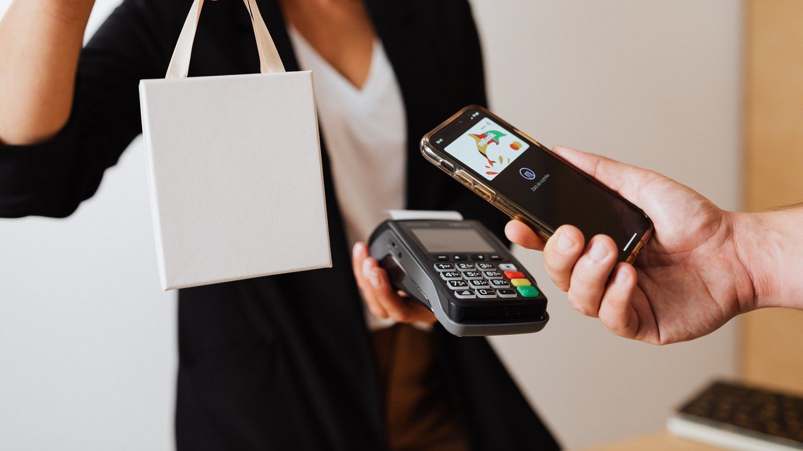 Stock photo of a person making a cashless payment with a mobile phone, illustrative only, not Synchrony's actual ChatGPT integration